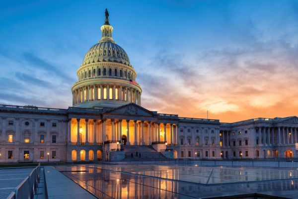 The capitol building in washington d.c. is lit up at night.