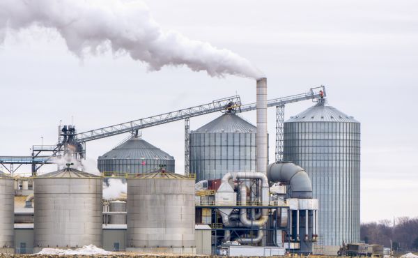 A factory with smoke coming out of the chimneys