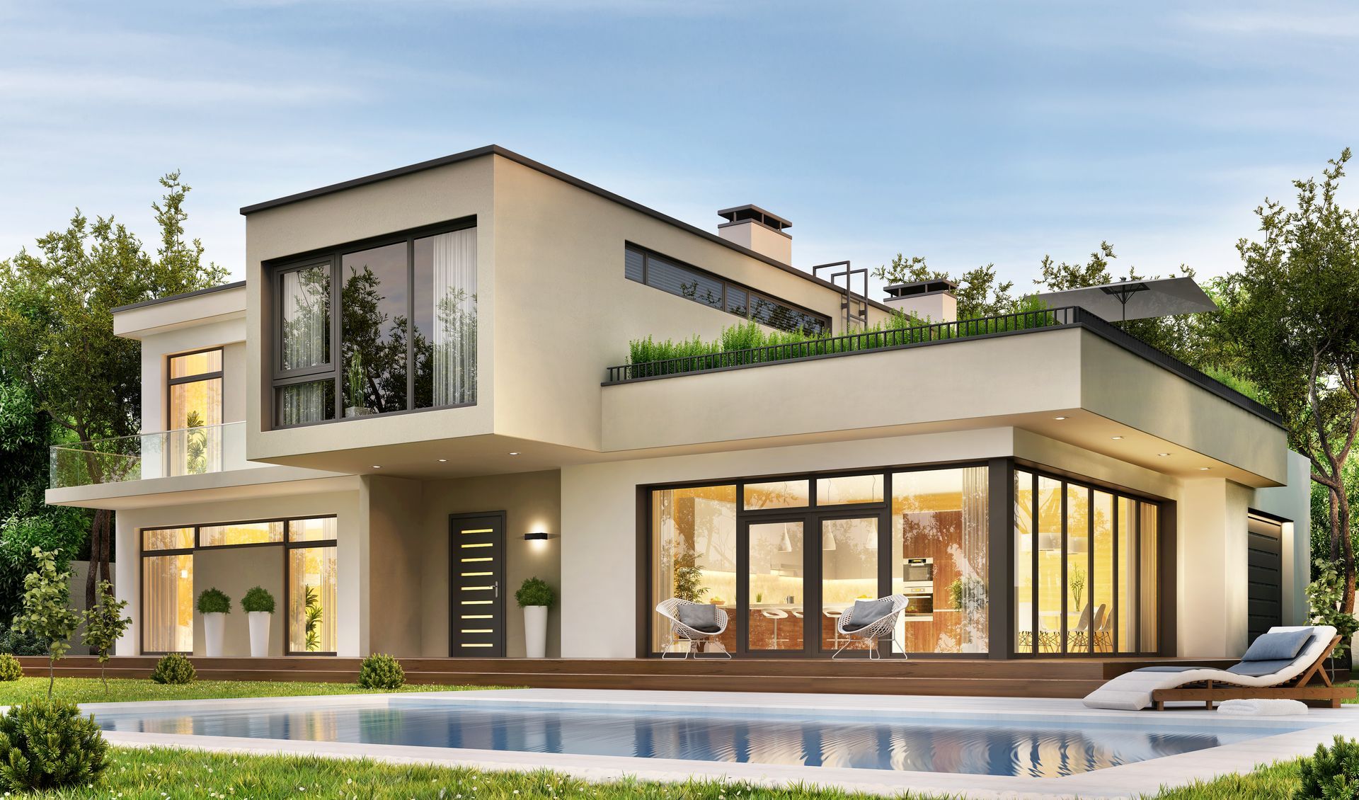 Modern two-story luxury villa with large glass windows, pool, and landscaped terrace at sunset