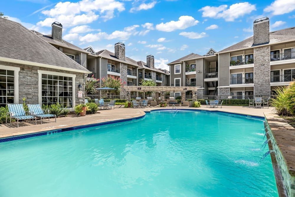 a large swimming pool in front of a large apartment building at Marquis on Westheimer in Houston, TX.
