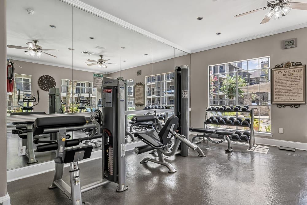 a large gym with a lot of equipment and a lot of mirrors at Marquis on Westheimer in Houston, TX.