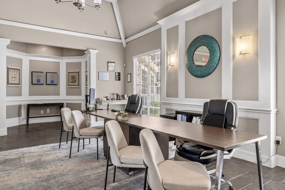 a room with a table and chairs in it and a mirror on the wall at Marquis on Westheimer in Houston, TX.