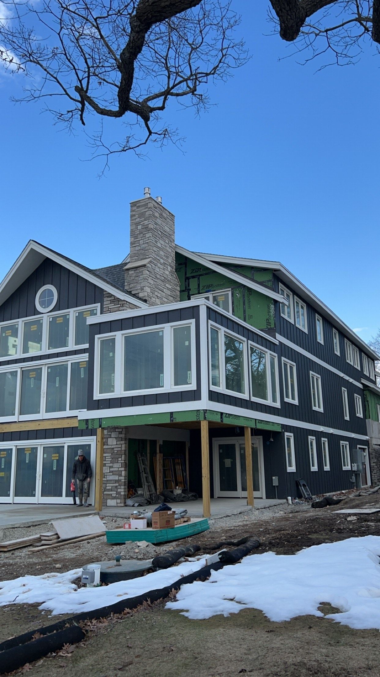 A large house with a lot of windows is being built.
