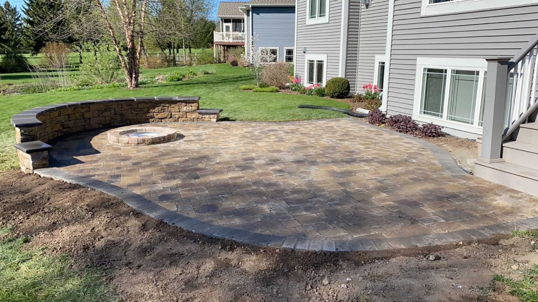 A patio is being built in front of a house.