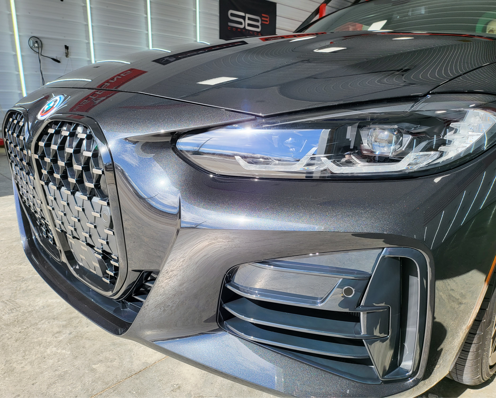 The front end of a bmw 4 series is shown in a close up.
