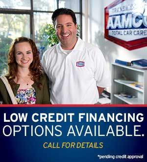 Woman and man at an AAMCO shop, offering low credit financing.