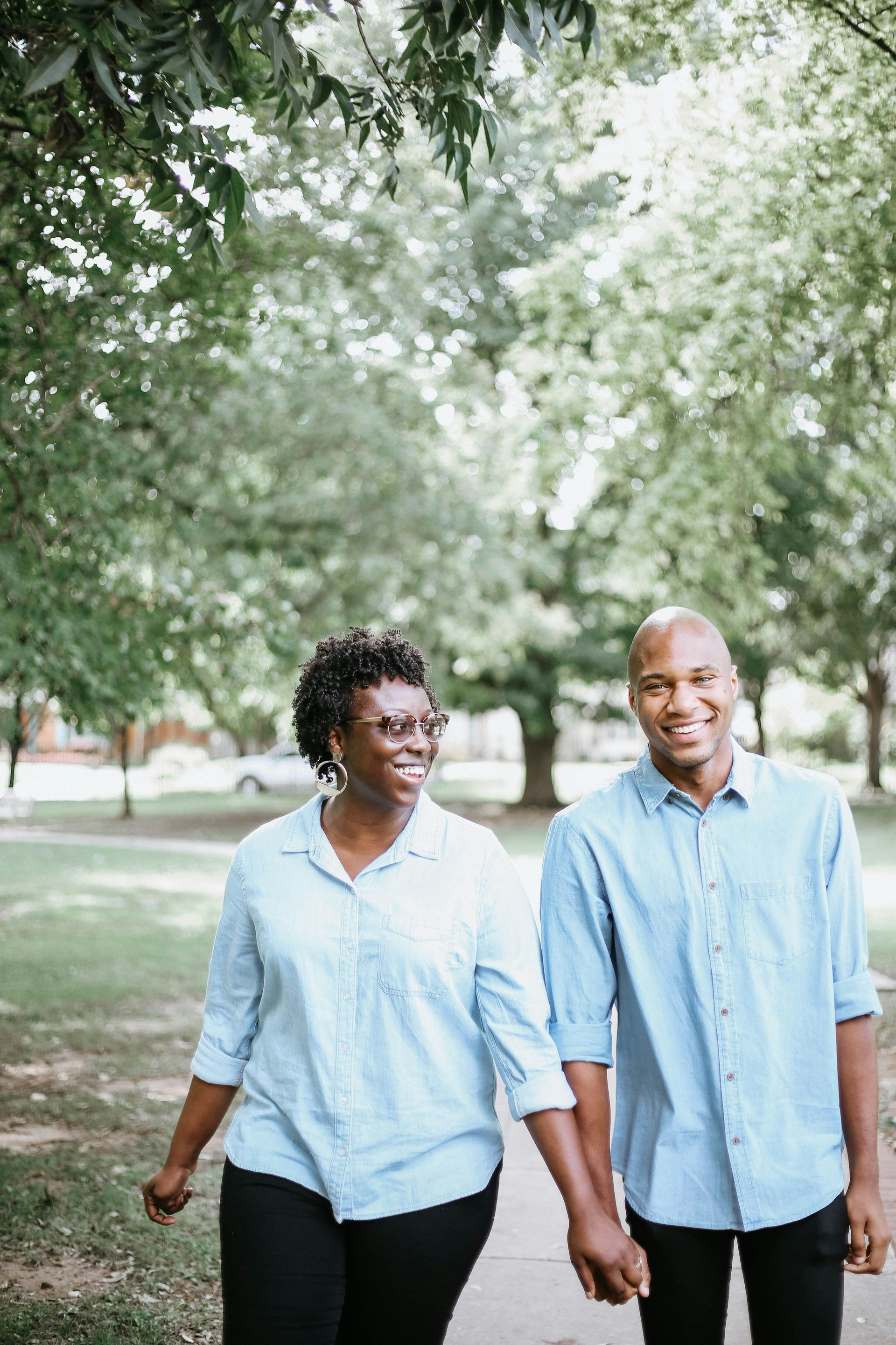A man and a woman are sitting on a couch talking to a woman.