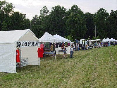 A row of tents with one that says official event services