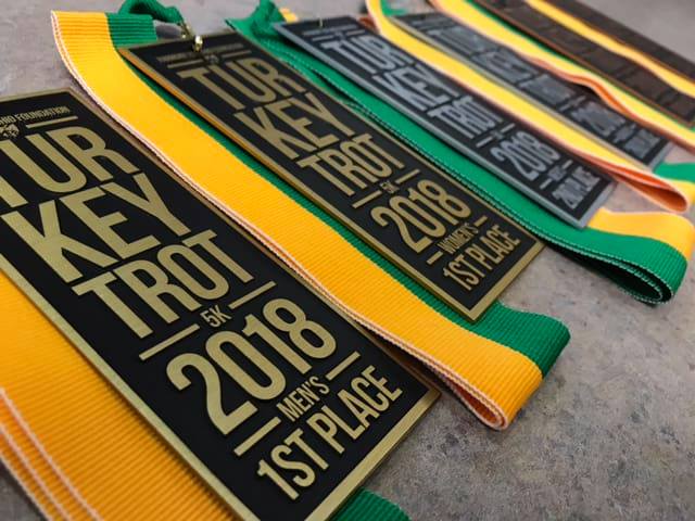 A row of medals for the turkey trot 2018 men 's 1st place