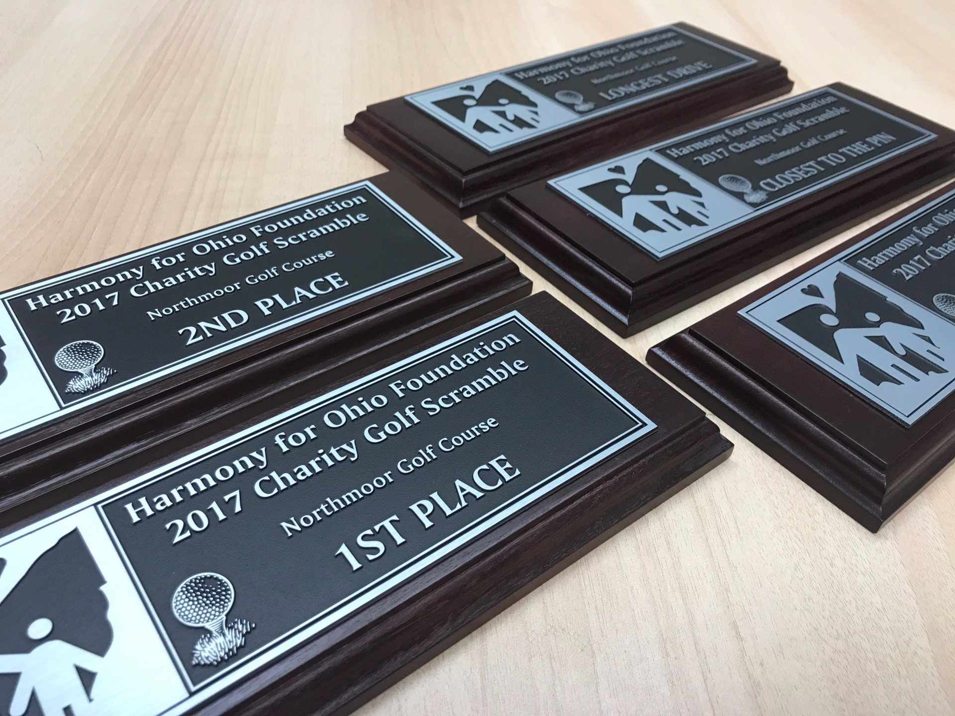 A stack of plaques with one that says 1st place