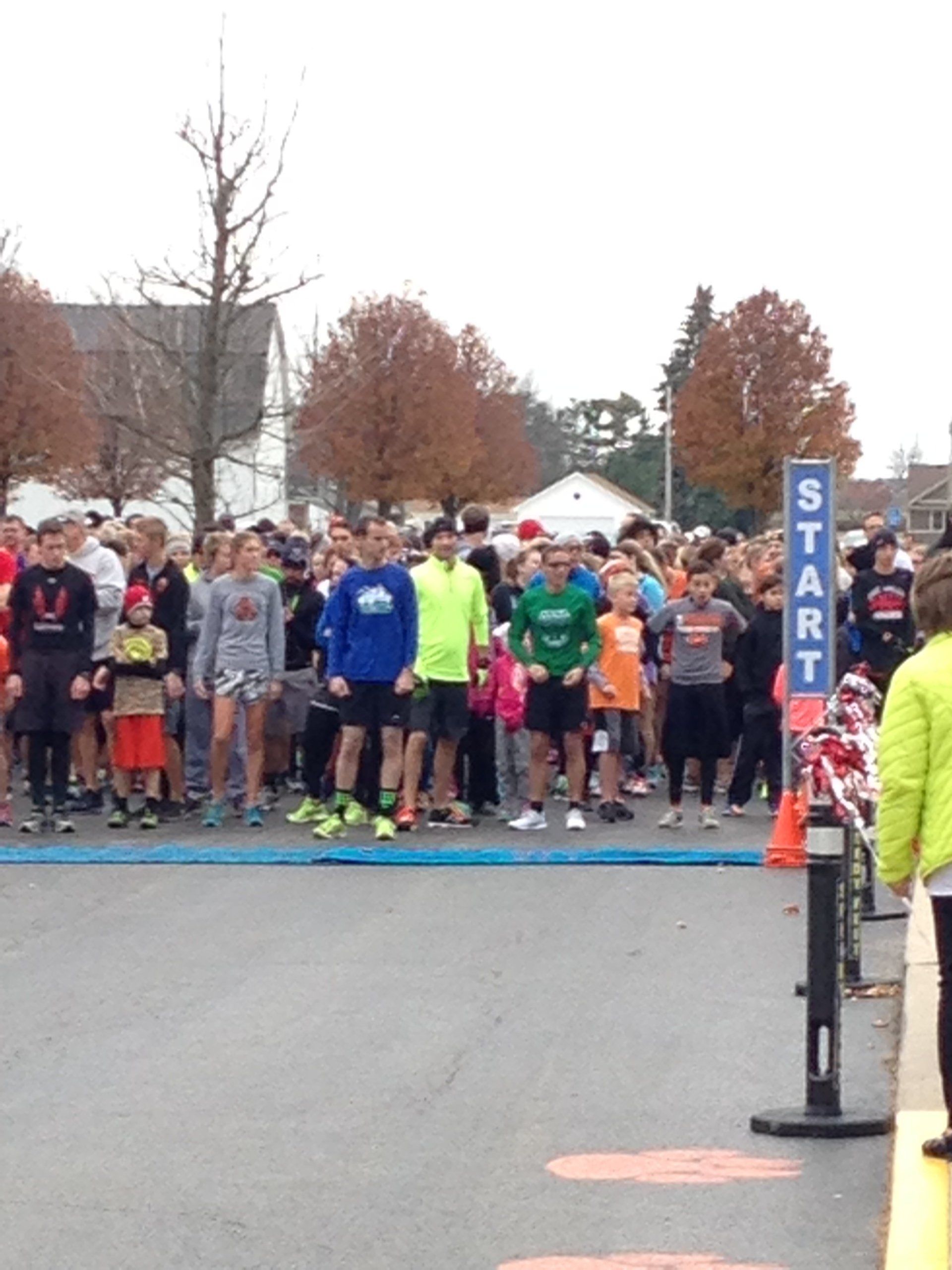 A group of people are gathered at the start of a race
