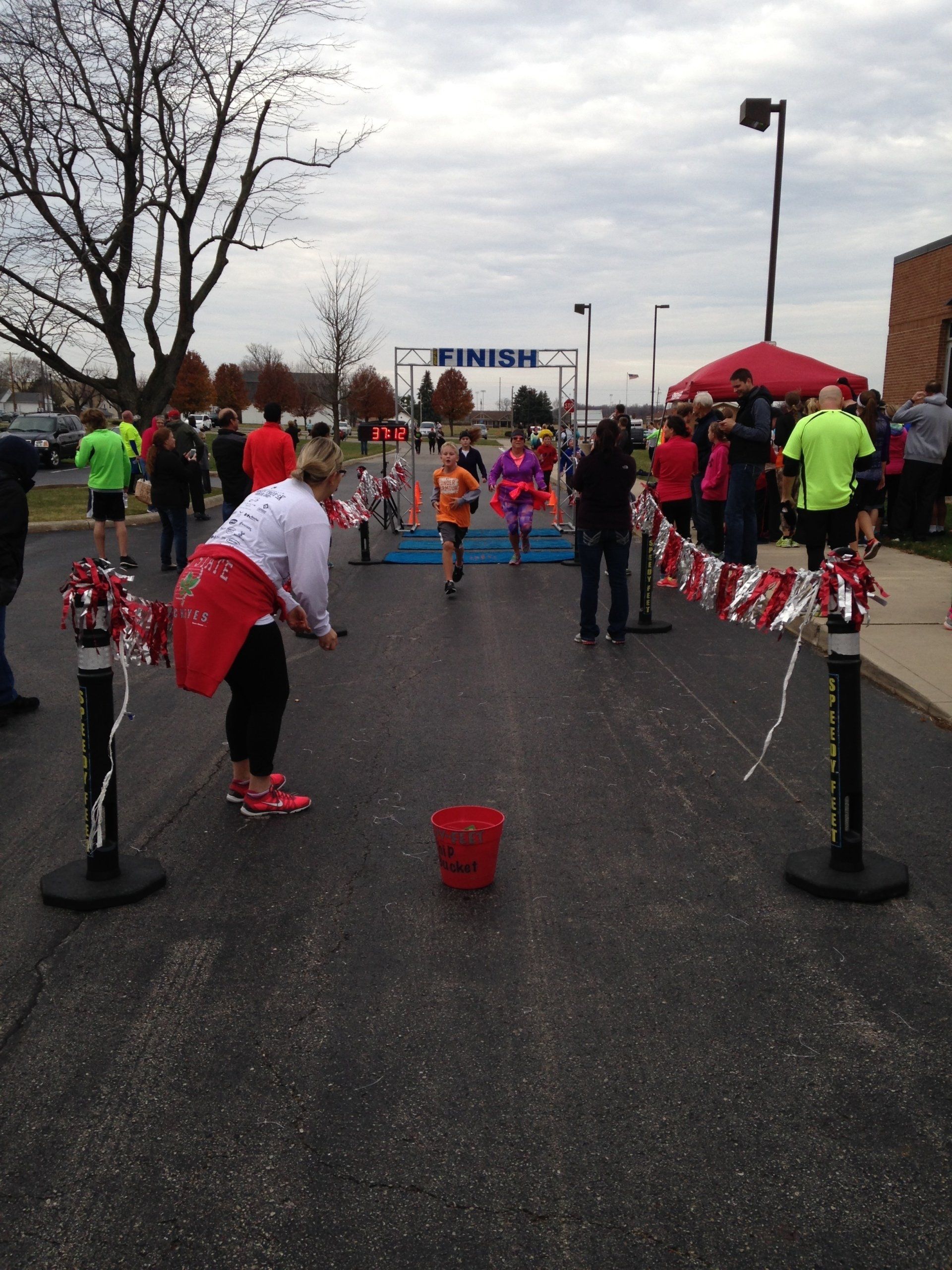 People are gathered at the finish line of a race