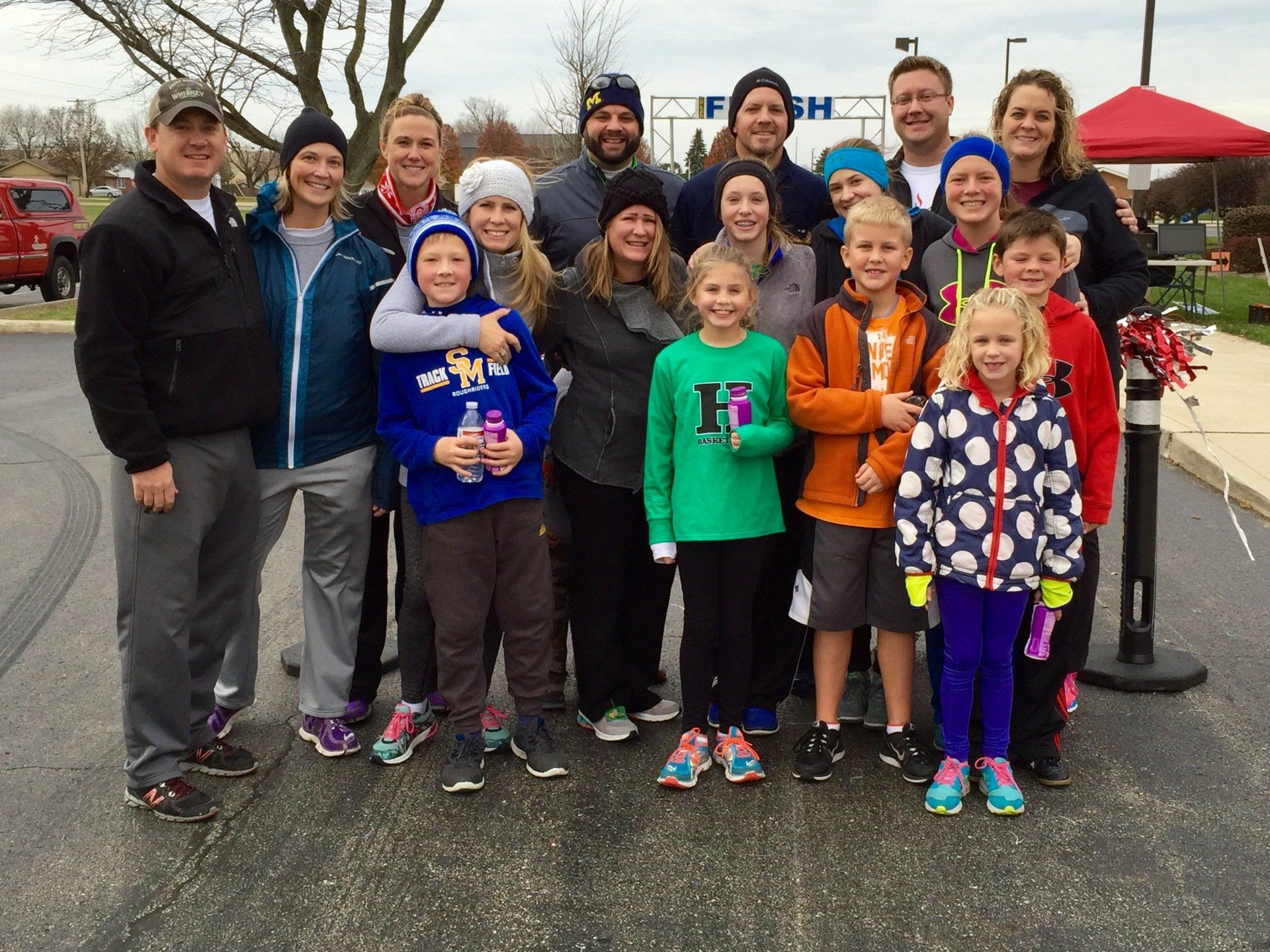 A group of people posing for a picture in front of a finish line