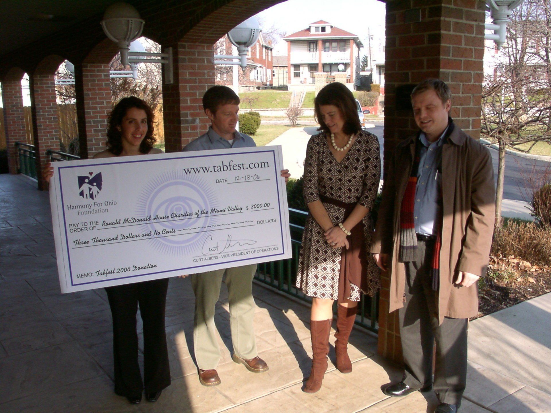 A group of people holding a large check that says ' awards ' on it