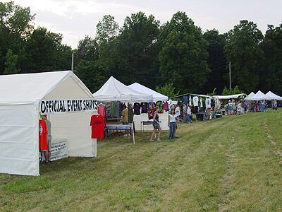 A row of tents with one that says official event services