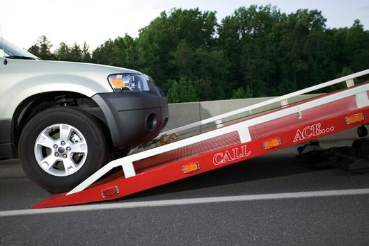 SUV being loaded on tow truck - Towing and Roadside Assistance in Sarasota, FL SUV being loaded on tow truck - Towing and Roadside Assistance in Sarasota, FL