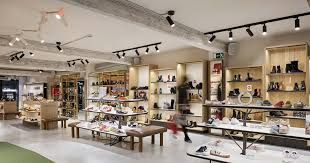 A large shoe store filled with lots of shoes on shelve lighting done by AARONS. 