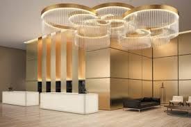 A lobby with a large chandelier hanging from the ceiling installation and project completed by AARONS.