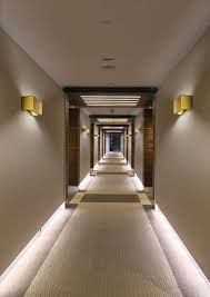 A long hallway in a hotel with a lot of lights on the walls project that AARONS completed/ 