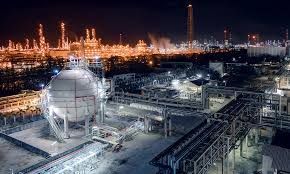 An aerial view of a large oil refinery at night lit up, project completed by Aarons lighting & Design. 