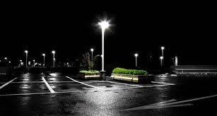 A black and white photo of a parking lot at night, project completed by Aarons lighting & Design. 