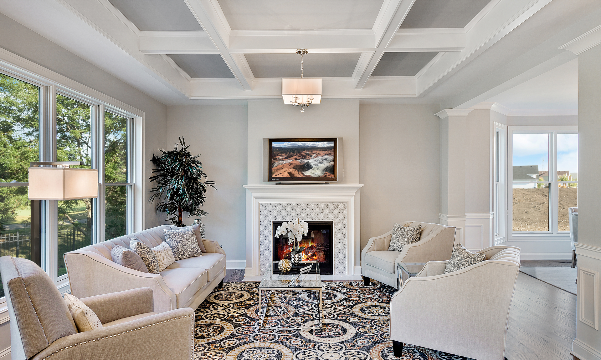 A living room with a couch , chairs , and a fireplace.