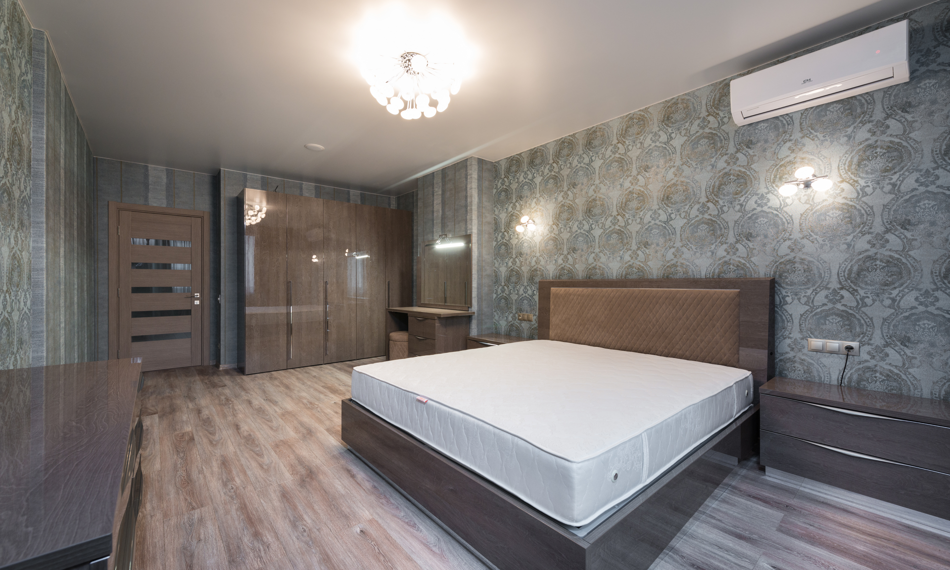 There is a large bed in the middle of the room. with beautiful lights.