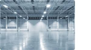A large empty warehouse with a concrete floor and ceiling.