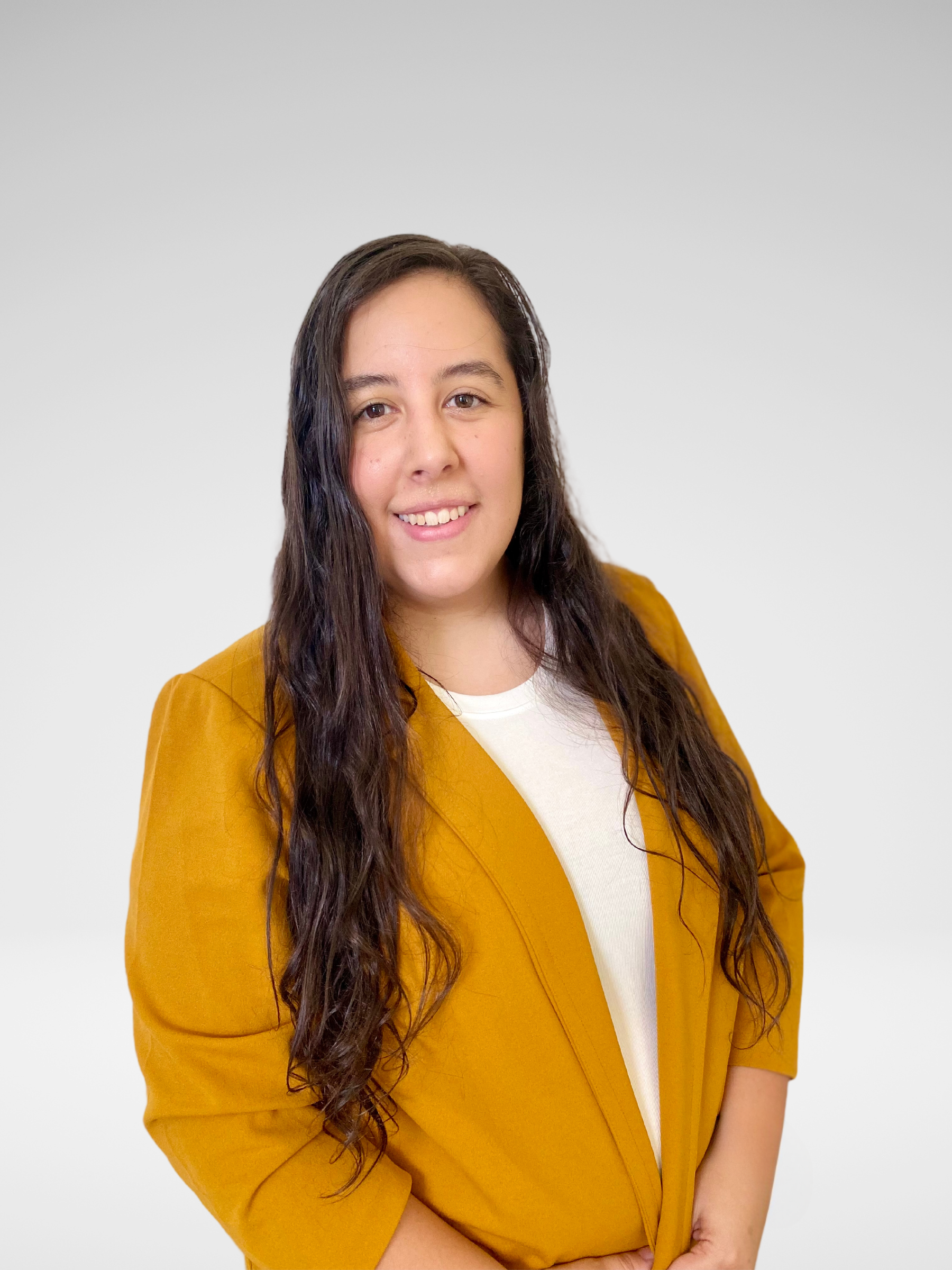 A woman with long hair is wearing a yellow jacket and a white shirt.