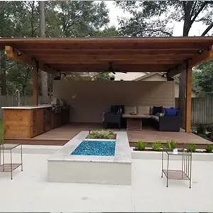 Modern patio with wood pergola, white seating area, and a small rectangular water feature in front