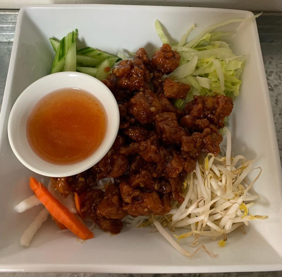 A plate of food with a small bowl of sauce