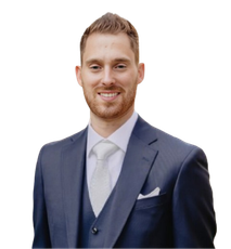 A man in a suit and tie is smiling for the camera
