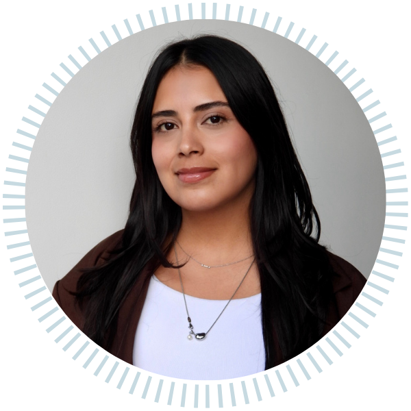 A woman in a plaid jacket and black shirt smiles in a circle