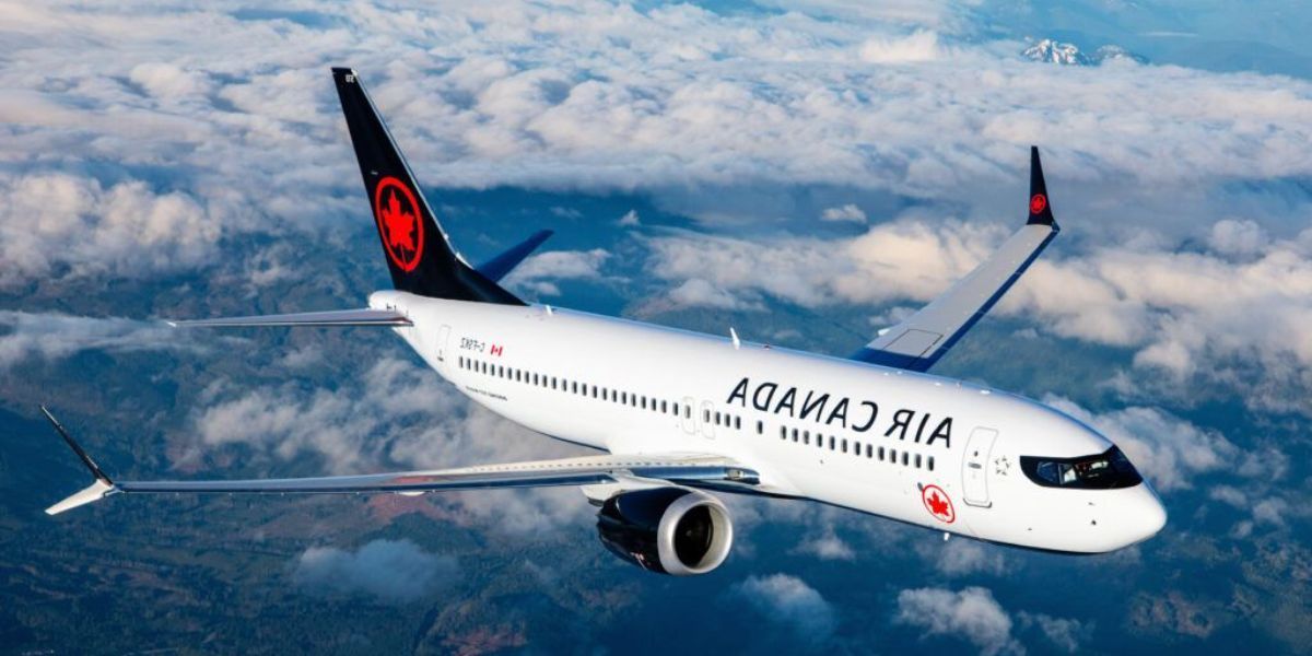 Air Canada airplane flying through clouds.