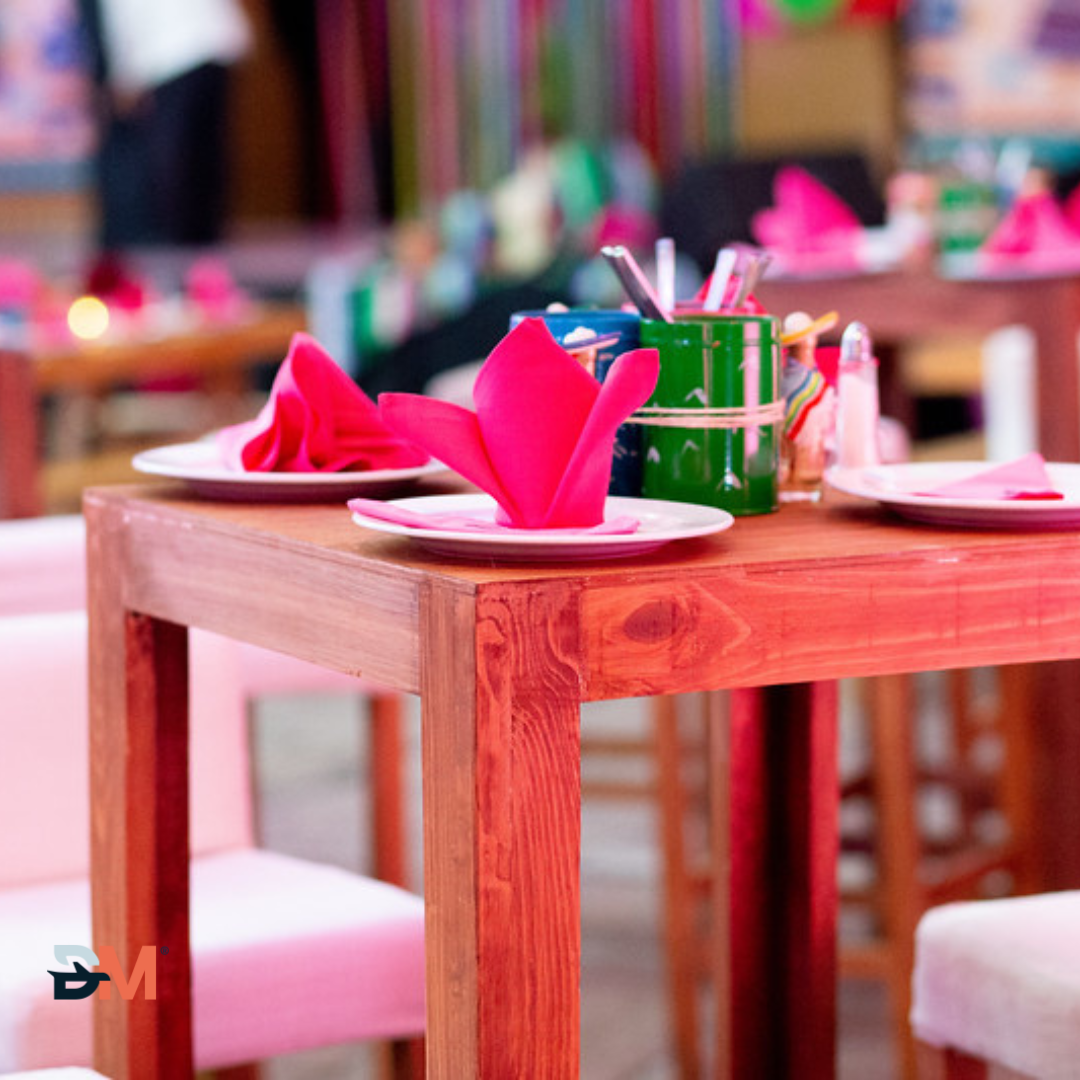 A wooden table with plates and napkins on it