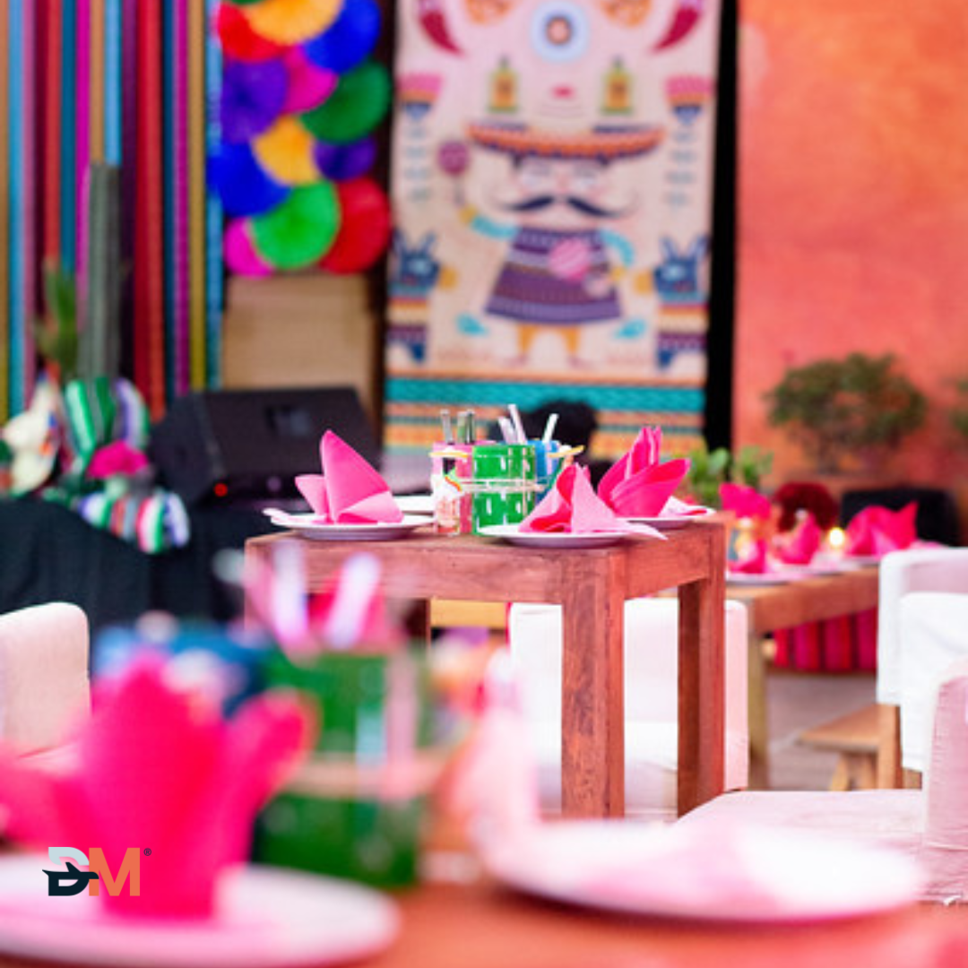 A blurred image of a table with plates and napkins with the letter m in the foreground