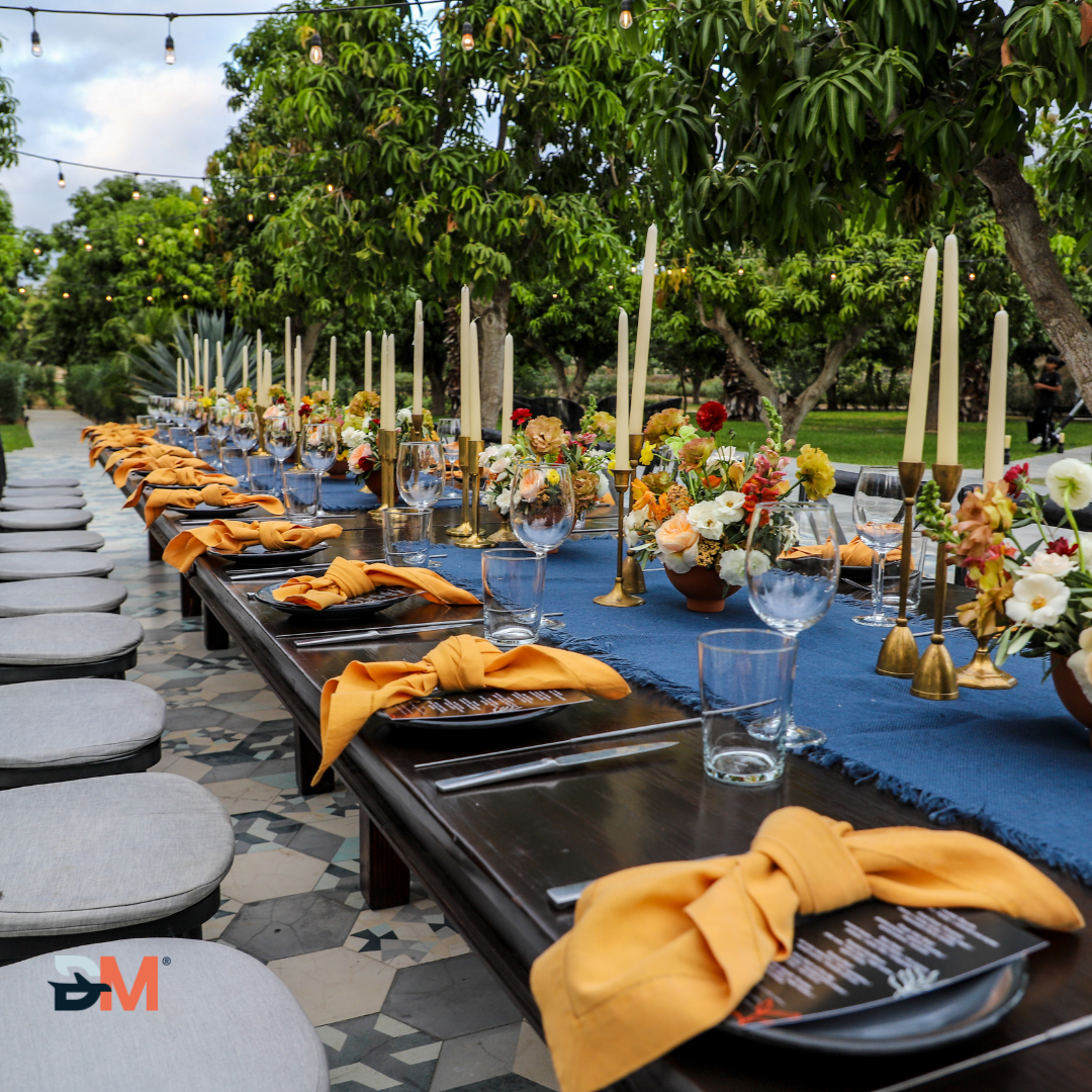 A long table with plates candles and flowers on it