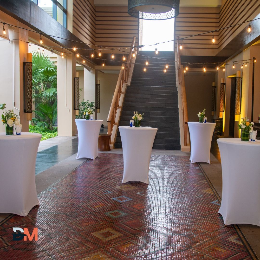 A room with tables and a staircase in the background