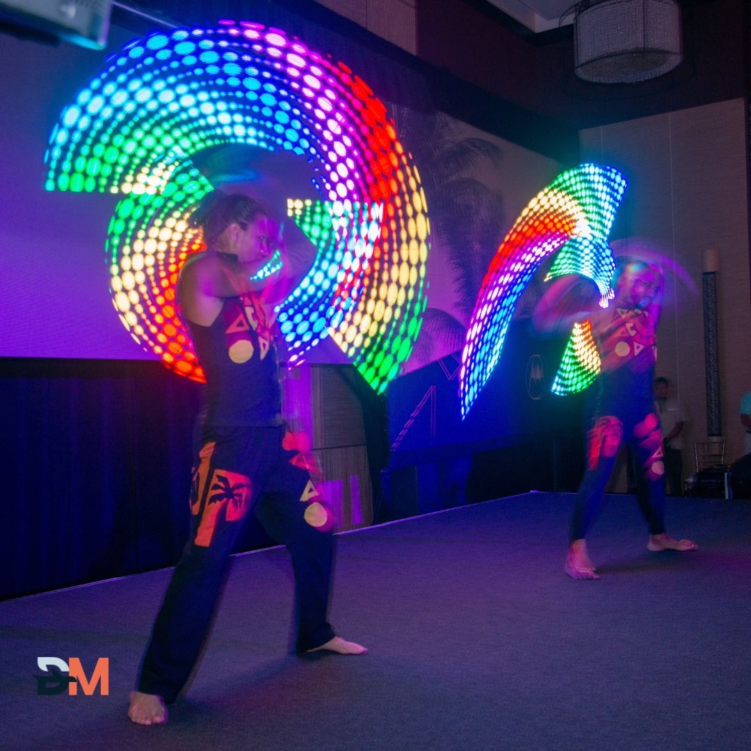 A couple of people standing on a stage with dm in the corner