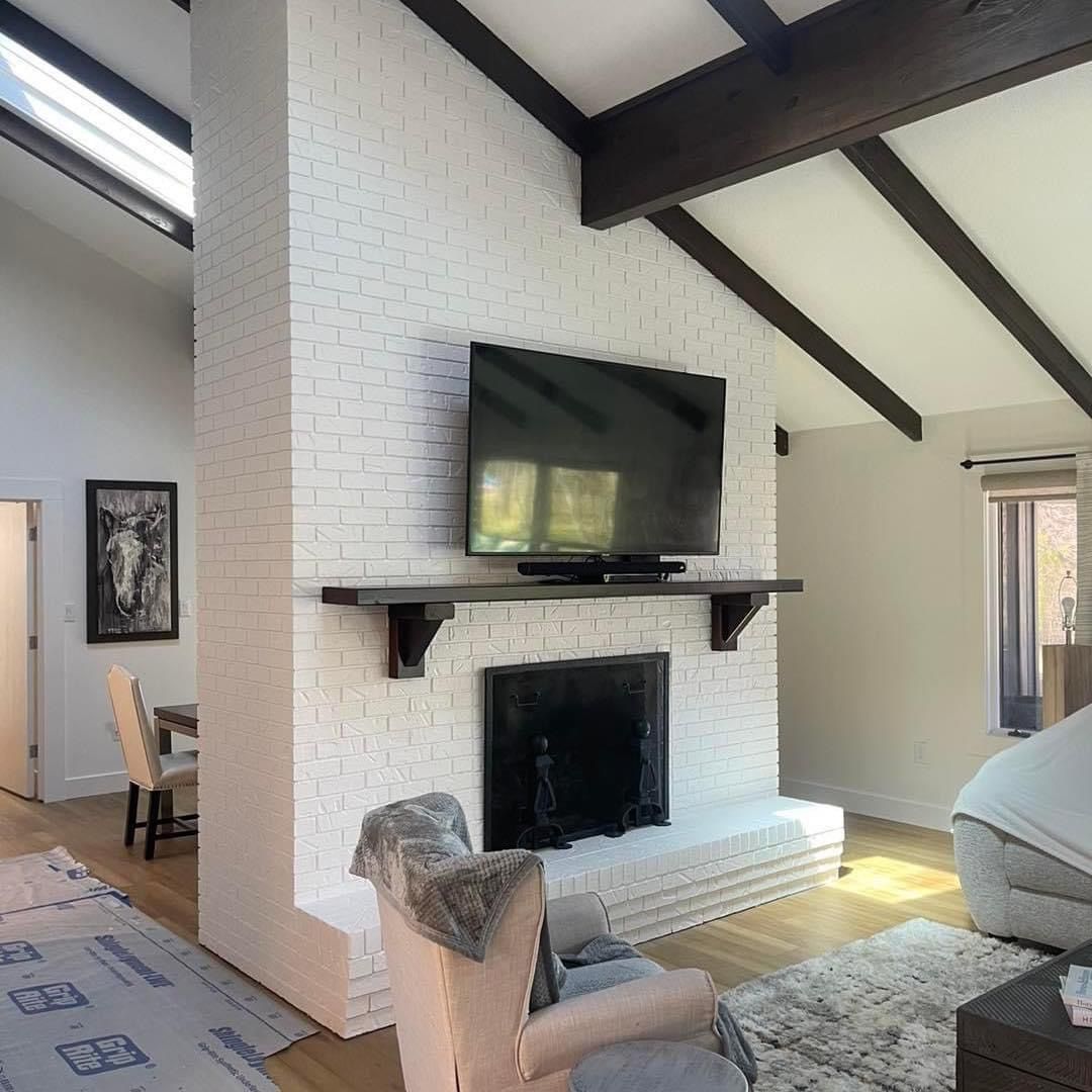 A living room with a fireplace and a flat screen tv