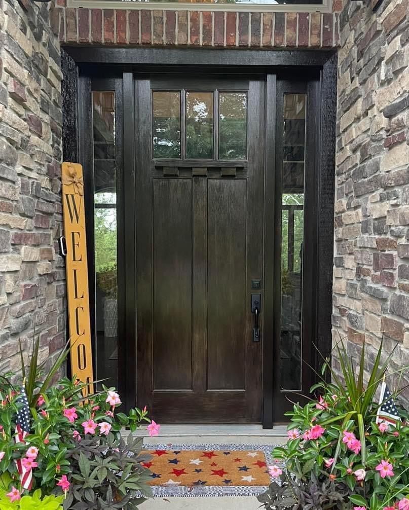 There is a welcome sign in front of the door.