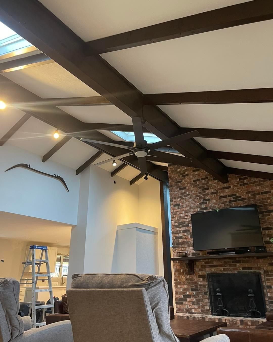A living room with a ceiling fan and a fireplace