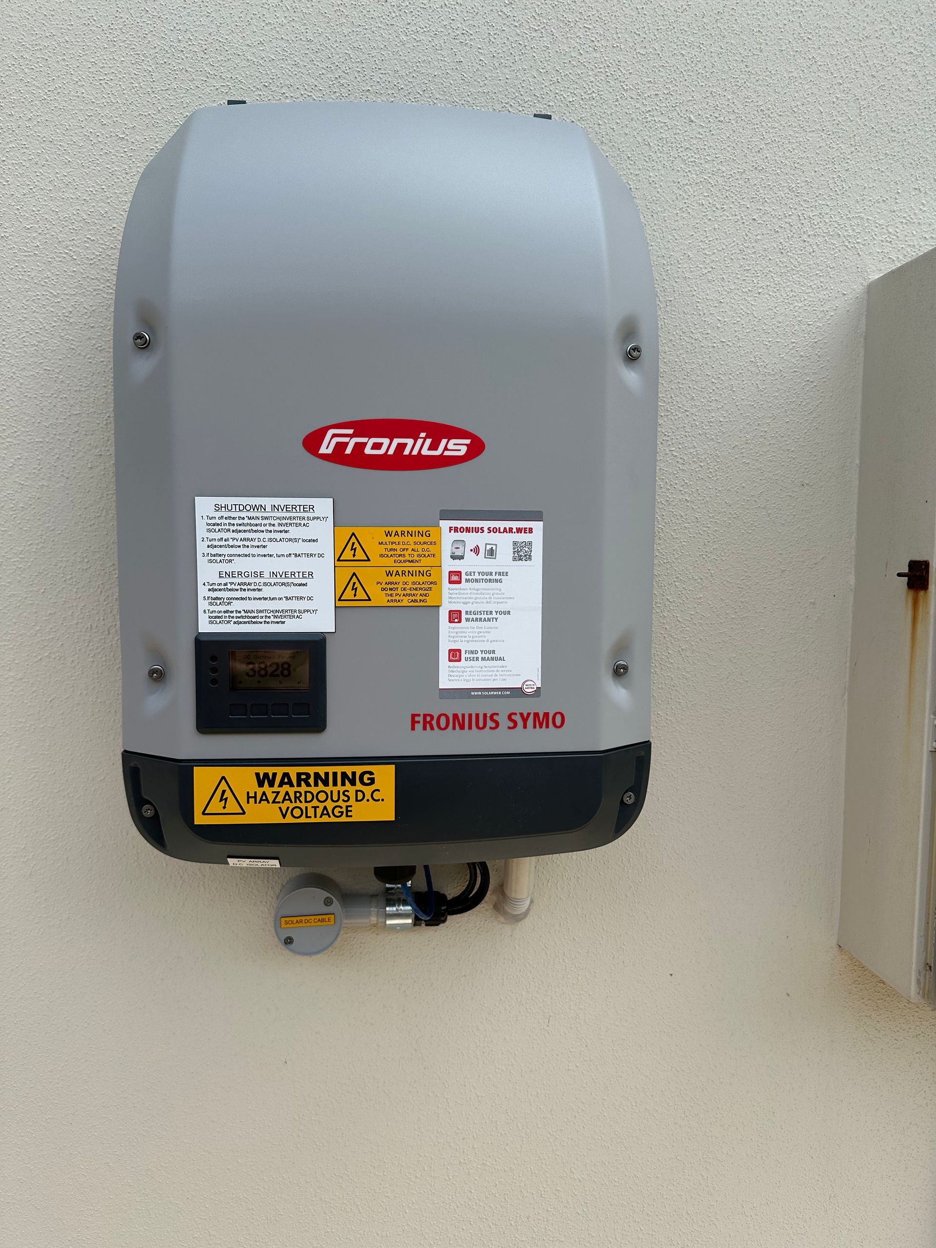 A framus solar inverter is mounted on a wall — B2B Electrical and Solar In Currimundi, QLD A framus solar inverter is mounted on a wall — B2B Electrical and Solar In Currimundi, QLD