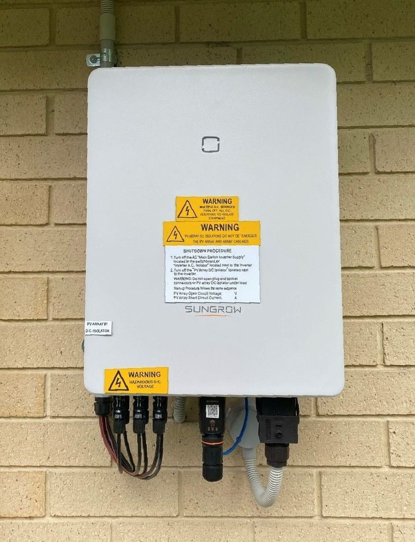 A solar panel is mounted on the side of a building. — B2B Electrical and Solar In Currimundi, QLD A solar panel is mounted on the side of a building. — B2B Electrical and Solar In Currimundi, QLD