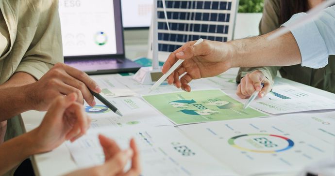 A Group of People Are Sitting Around a Table — B2B Electrical and Solar In Currimundi, QLD
