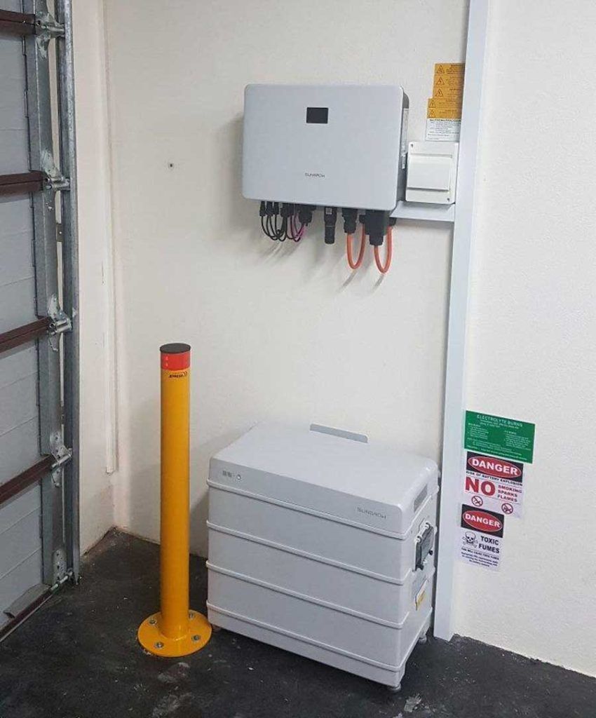 Two Batteries are Connected to a Charger in a Room — B2B Electrical and Solar In Currimundi, QLD
