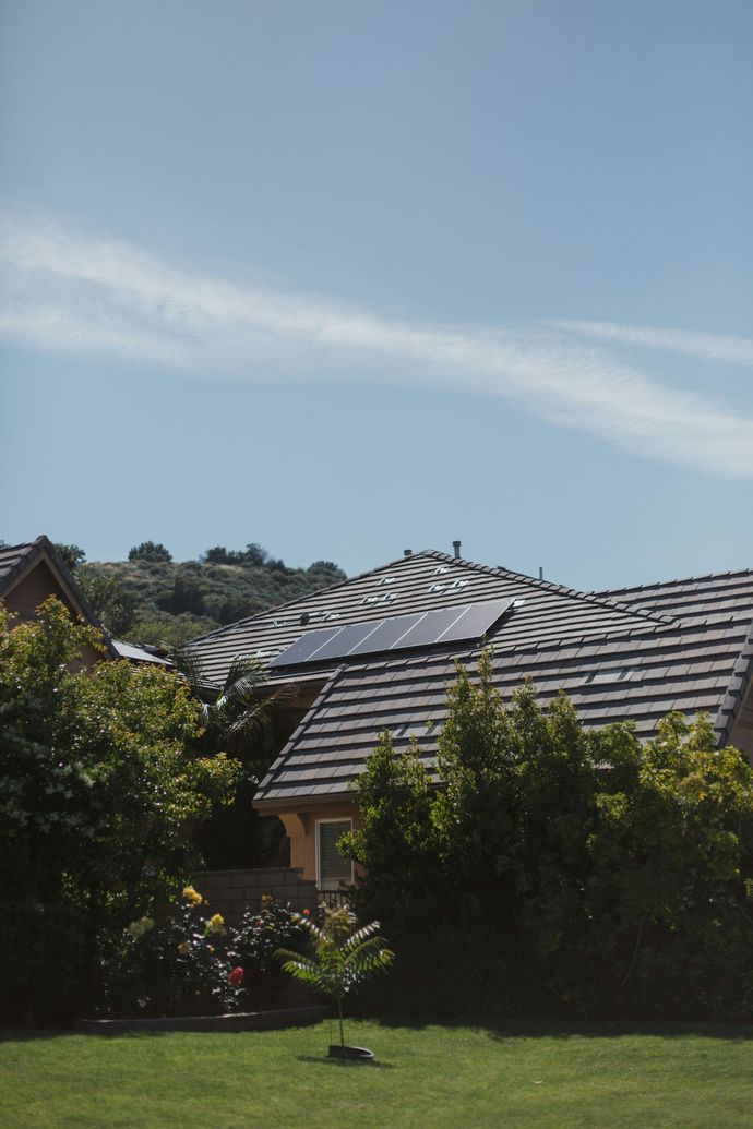 A Solar Panel is Mounted on the Side of a Building — B2B Electrical and Solar In Currimundi, QLD A Solar Panel is Mounted on the Side of a Building — B2B Electrical and Solar In Currimundi, QLD