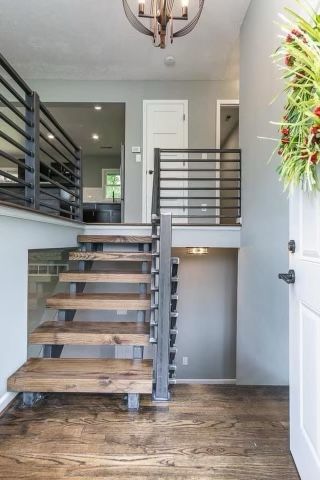 A wooden staircase leading up to the second floor of a house