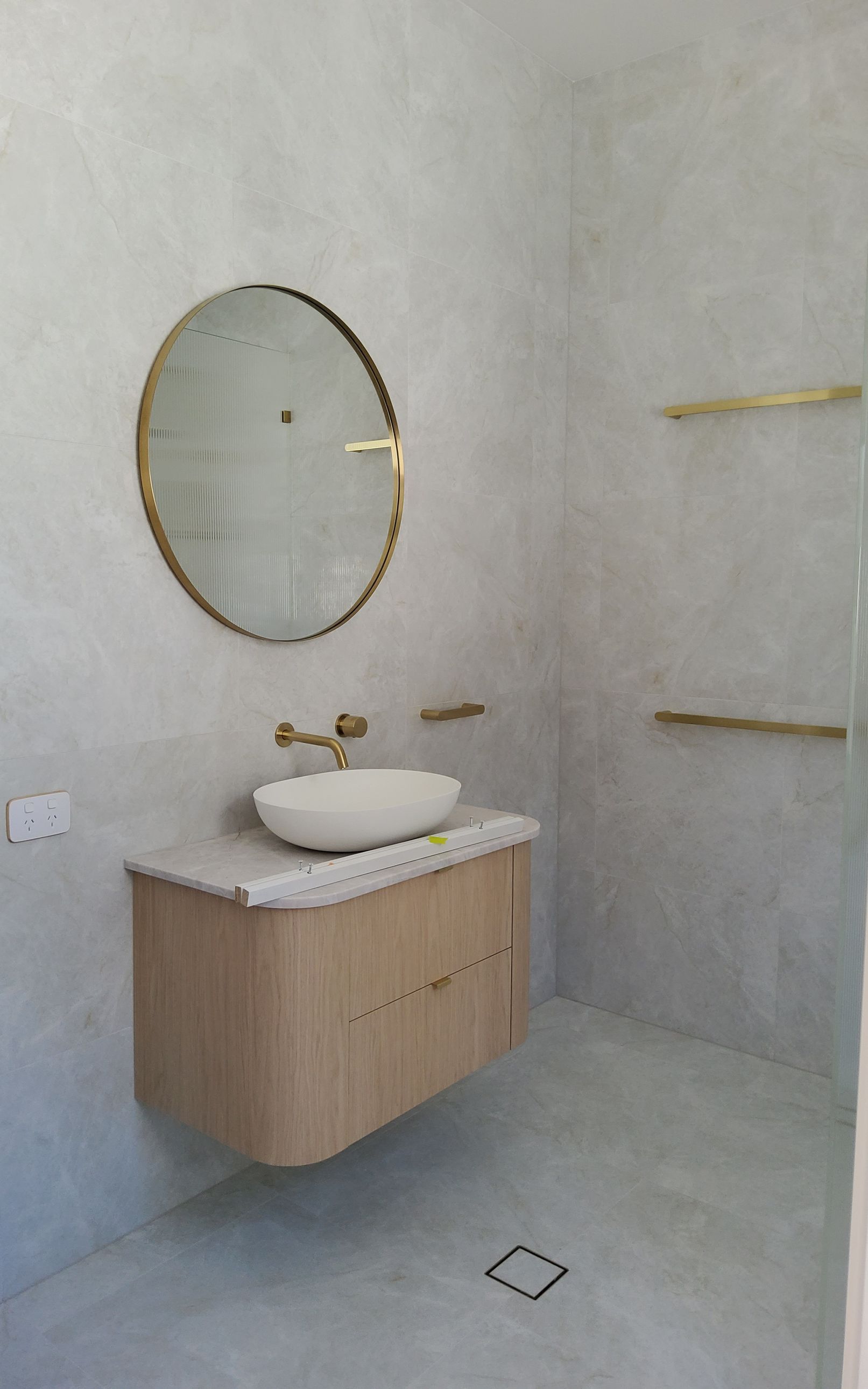 Modern Bathroom With Gold-Trimmed Mirror