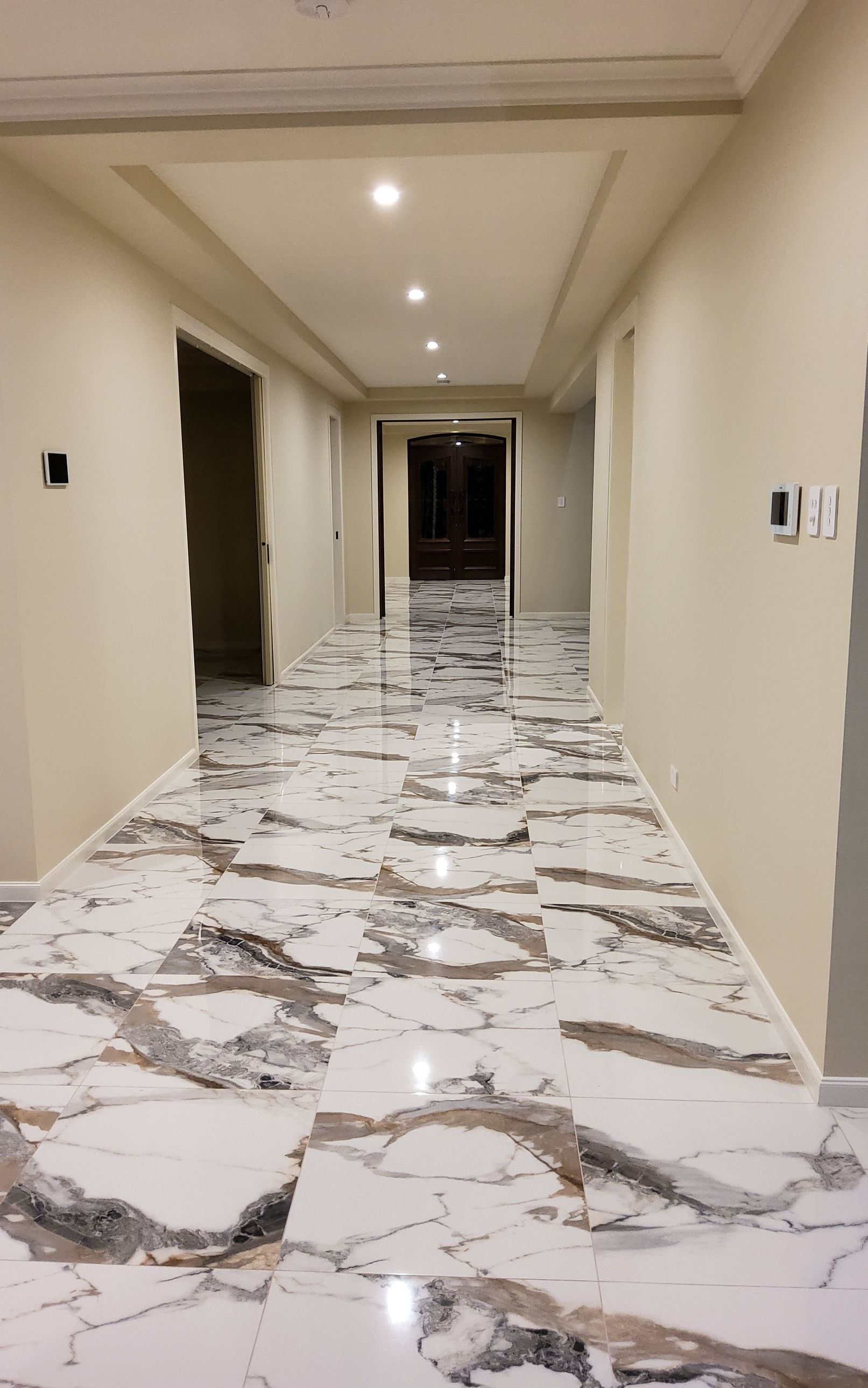 Shiny Marble Tiles In Long Hallway
